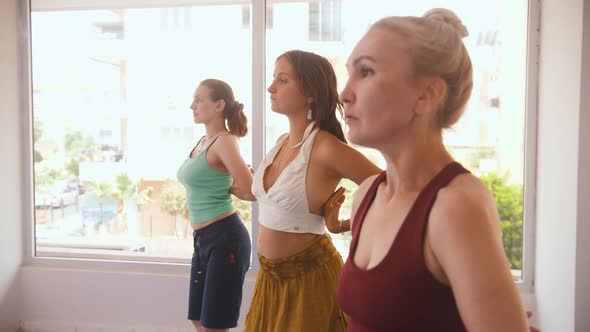 Three Women Having Yoga Classes in the Studio  Running Their Hands Above the Chest