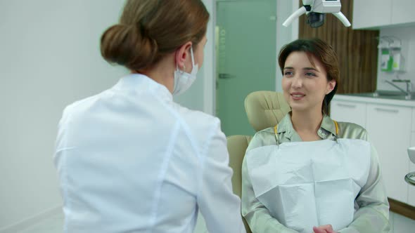 Smiling Girl Talks To Doctor in Clinic