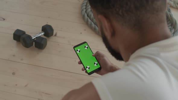 Fit Man With Smartphone At Gym