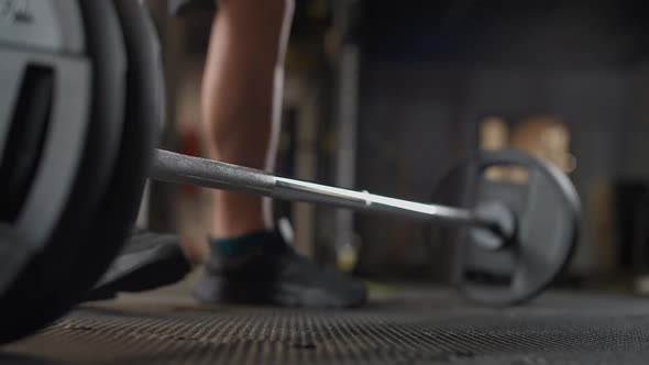 Anonymous Athletic Man Performs a Deadlift with Barbell Lifts Barbell and Does Weights Training in