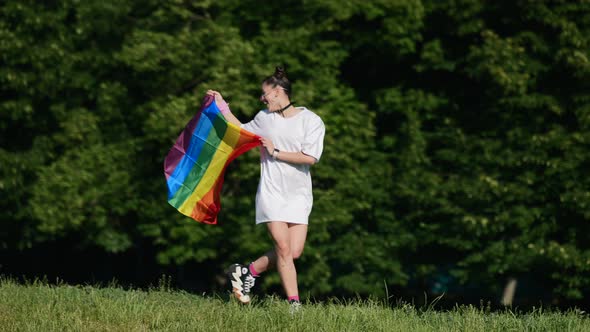 Young Woman with Lgbt Pride Flag Walking in the Park