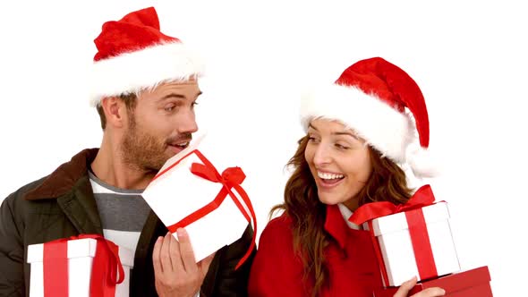 Attractive young couple wearing santa hats with gift