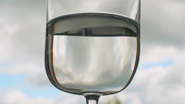 Timelapse of Clouds Reflecting in Water Glass, Concept of Life Passing