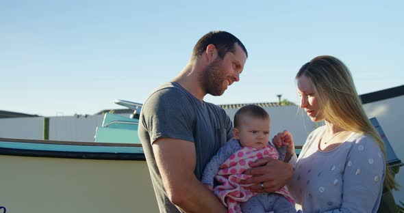 Parents holding baby boy at backyard 4k