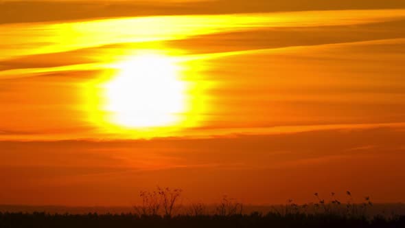 Timelapse Sunset in the Sky Big Bright Yellow Sun Moves Down on the Horizon