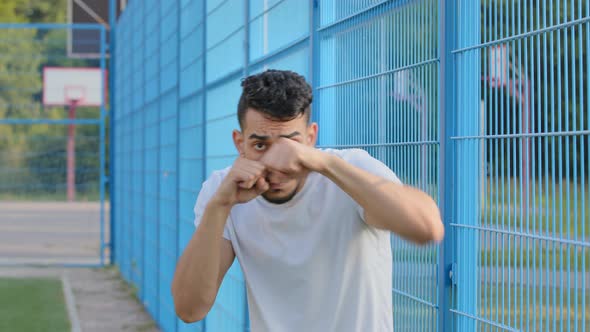 Portrait Serious Angry Tense Middle Eastern Indian Boxer Pounding Air with Clenched Fist