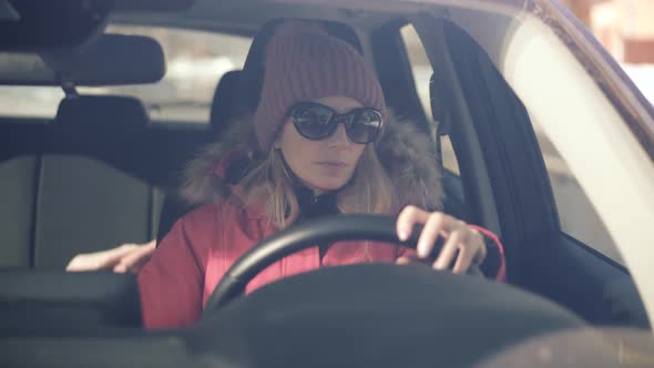 Woman Driver Hand On Car Steering Wheels. City Road Transportation Travel Mobility  In Car.