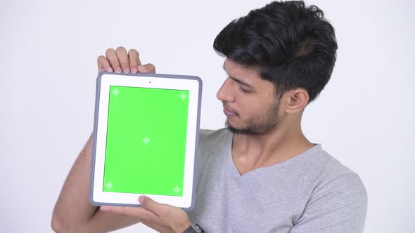Young Happy Bearded Indian Man Showing Digital Tablet