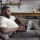 African American Businessman Distance Works at Laptop Online Chatting with Company Employees on Sofa - VideoHive Item for Sale