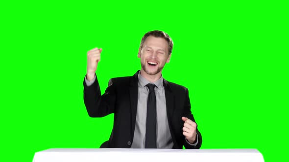 Happy Businessman Sitting at the Table. Green Screen