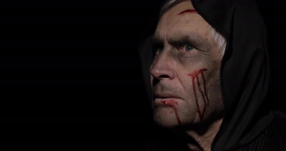 Old Executioner Halloween Makeup and Costume. Elderly Man with Blood on His Face