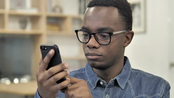 Excited Happy AfroAmerican Man Using Smartphone