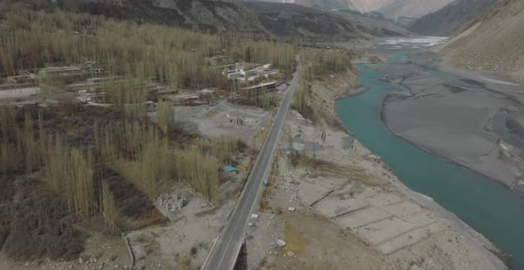 Aerial View Of Karakoram Highway Road Beside River At Hunza Valley. Circle Dolly