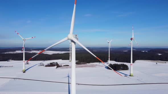 Orbiting a wind power plant with a drone. Circling a wind power plant in the air.