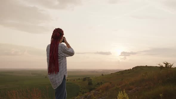 Back Side View of a Girl That Shoots the Sunset