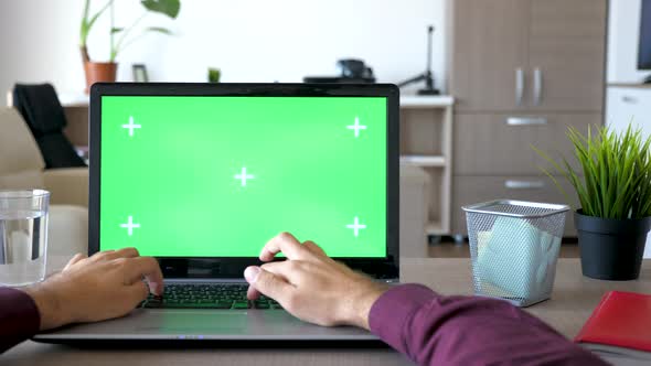 Businessman at Home Typing on Laptop with Green Screen Chroma Mock Up