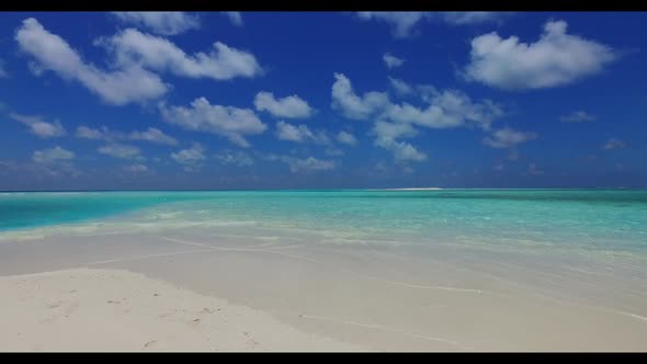 Aerial above scenery of perfect seashore beach break by transparent ocean and white sandy background