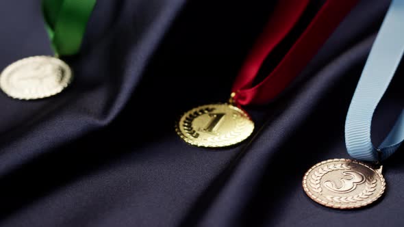 Gold Silver and Bronze Medals with Ribbons on Black Background Closeup