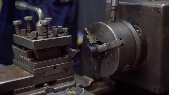 Worker Is Changing Detail in Turning Machine in Factory Workshop, Using Key, Close-up of Hands