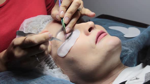 in a Beauty Salon a Woman Undergoes an Eyelash Extension Procedure