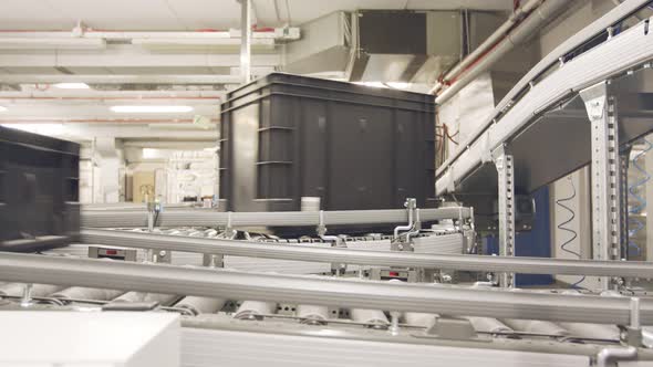 Boxes moving on conveyors in a large automated warehouse