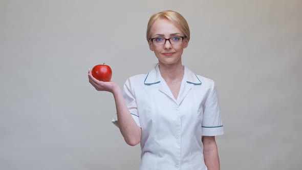 Nutritionist Doctor Healthy Lifestyle Concept - Holding Organic Red Apple and Alarm Clock
