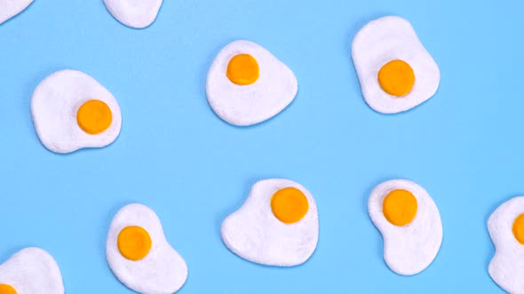 Rotating Background of Scrambled Eggs on a Blue Background Closeup Top View