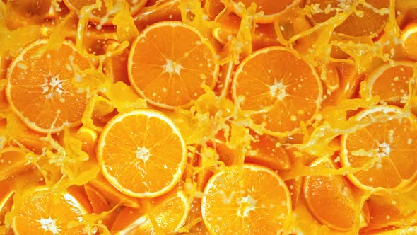 Super Slow Motion Shot of Fresh Orange Juice Splashing Through Orange Slices at 1000Fps