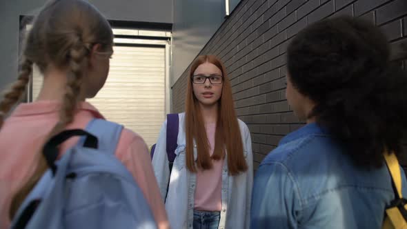 Confused Red-Haired Teenager in Eyeglasses Passing by Cruel Classmates, Conflict