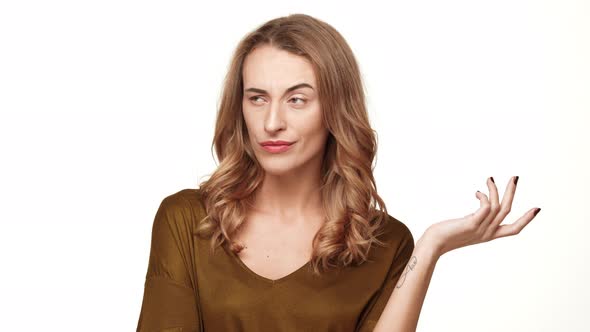 Displeased Middleaged Female with Long Brown Hair Looking at Camera with Claim on White Background