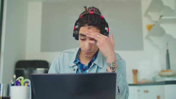 Tired Arabic Male Student Studying Online Course