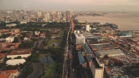 Sunset Cityscape with Designed Park and Ponds at Ocean Bay Aerial