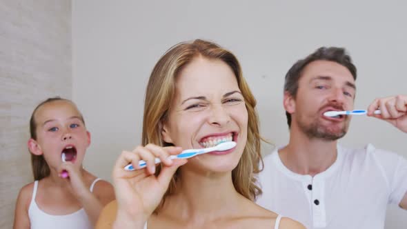 Happy family brushing teeth