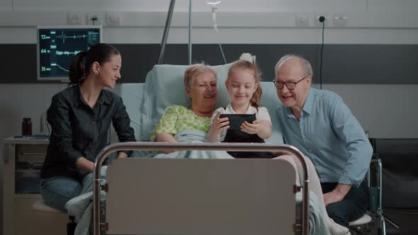 Child Taking Selfie with Patient and Family in Visit Using Smartphone