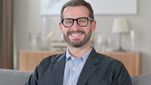 Portrait of Happy Young Businessman Smiling at Camera 