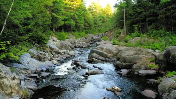 Aerial shot over Piscataquis River at Barrel Falls.