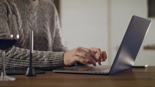 Young Male Freelancer Working on a Laptop and Smartphone