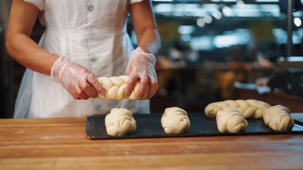 Woman making a bagel pastry with her hands