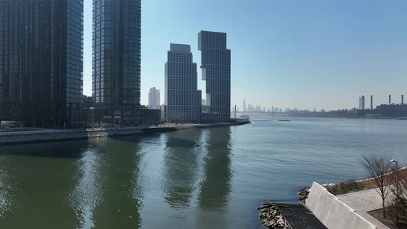 An aerial view of Newtown Creek with new high-rise apartment buildings in Brooklyn, NY in the backgr