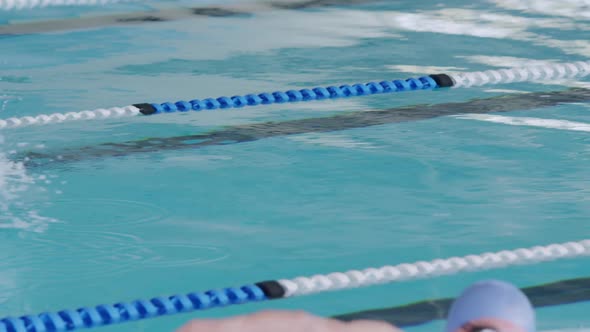 Swimmers swimming into the pool