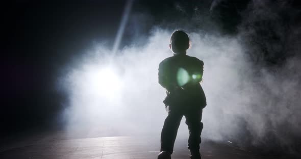 silhouette of a female dancer performing hip hop dance in slow motion