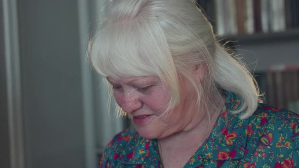 Portrait of Happy Grandmother Smiling at Camera During Cooking Process