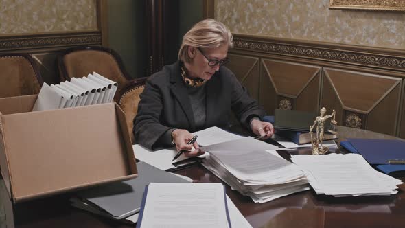 Female Lawyer Working with Documents in Office