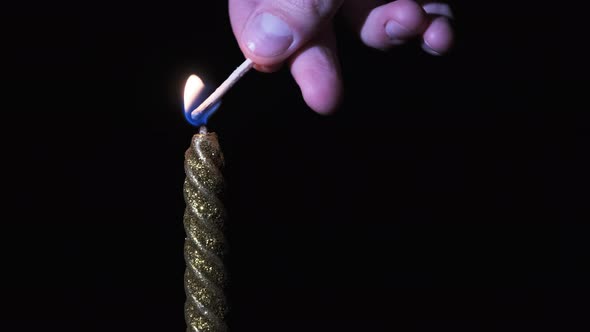 A Single Candle Is Lit on a Black Background. Candle Flame in the Dark. alt