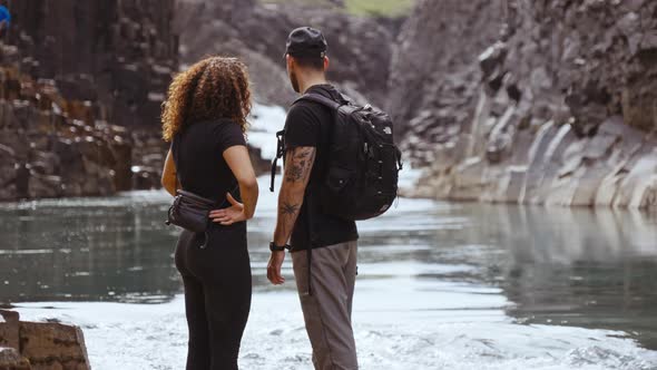 Awesome Shot of Tourists Looking at the View of Studlagil Canyon by the River