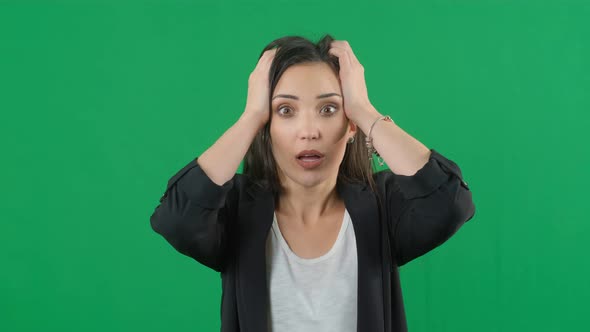 Portrait of Amazed Young Woman Over Green Screen Background for Keying. Shocked Woman with Mouth