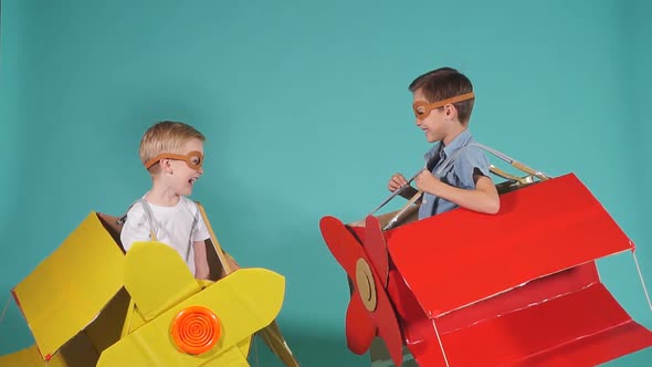 Cute Small Boys in Cardboard Planes