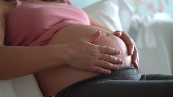 Happy Pregnant Woman and Expecting Baby at Home