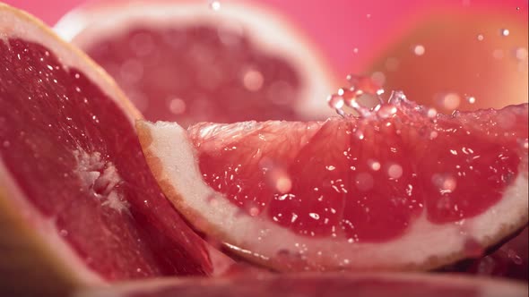 Slow Motion Shot of Grapefruit Juice Splashing Through Grapefruit Slices