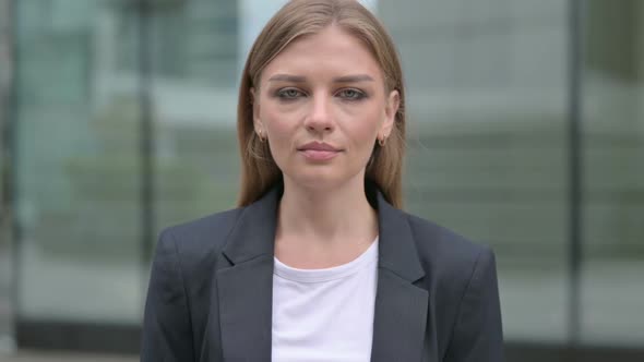 Portrait of Serious Businesswoman Looking at the Camera Outdoor